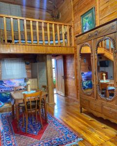 a dining room with a table and a bunk bed at Chalet Gyumri in Gyumri