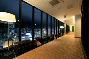 a room with a view of a city at night at Candeo Hotels Kobe Tor Road in Kobe +34 photos