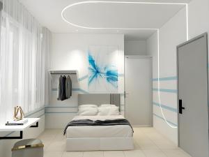 a bedroom with a white bed and a blue painting at One Stop Hotel Ipoh in Ipoh +75 photos