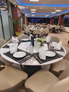 a dining room with a large table and chairs at Glam Hotel Nairobi - Near Westgate Mall, Westlands in Nairobi