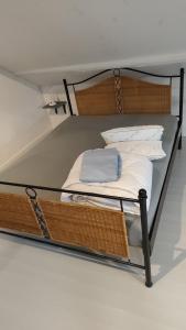 a bunk bed with a metal frame and white pillows at Villa AIMÉ SALMCHÂTEAU in Vielsalm