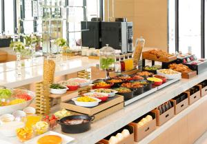 a buffet line with many different types of food at Candeo Hotels Kobe Tor Road in Kobe