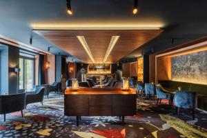 a lobby of a hotel with chairs and a table at Hotel Pieniny Grand Wellness & SPA - Destigo Hotels in Szczawnica