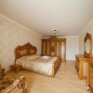 a bedroom with a bed and a wooden dresser at Guest House Mari in Ureki