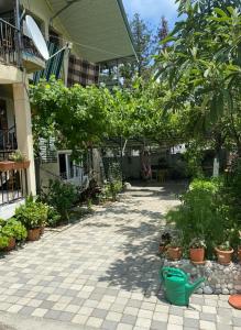 a courtyard with potted plants and trees in a building at Guest House Mari in Ureki
