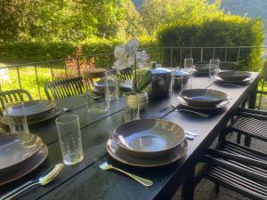 a wooden table with plates and glasses on it at Haus Renard in Rodund +17 photos