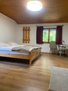 a bedroom with a large bed in a room with a table at Haus Renard in Rodund