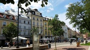 a city street with a building with a clock tower at Old Town Art Studio in Warsaw