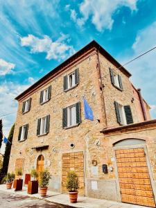 a large brick building with two garage doors at Agriturismo CasaViVa in Pozzo
