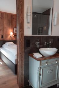 a bathroom with a sink and a bed at Löw Chalet Suite 2, Steps from the Slopes by 360 Estates in Kitzbühel