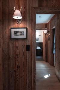 a hallway in a house with wooden walls and a light fixture at Löw Chalet Suite 2, Steps from the Slopes by 360 Estates in Kitzbühel