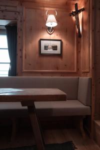 a dining room with a bench and a ceiling fan at Löw Chalet Suite 2, Steps from the Slopes by 360 Estates in Kitzbühel +2 photos