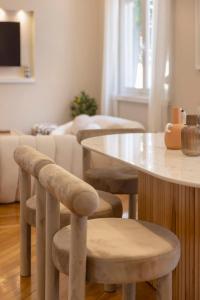 a living room with a table and some chairs at Kallirois Avenue House 7ppl 2BR Acropolis Metro Plaka 300m in Athens