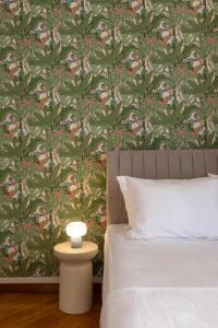 a bedroom with a bed with a green and pink wallpaper at Kallirois Avenue House 7ppl 2BR Acropolis Metro Plaka 300m in Athens