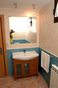 a bathroom with a sink and a mirror at Casa Miguel Périz in Sorripas +17 photos