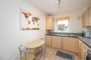 cocina con mesa y 2 taburetes en Aberdeen 2BR Flat Near Airport & City Centre, en Aberdeen 28 fotos más