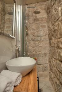 a bathroom with a white sink on a wooden counter at אבן יהלום in Safed