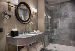a bathroom with a sink and a shower at NH Collection Colón Valencia in Valencia