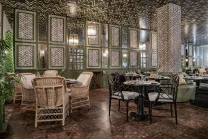 a restaurant with tables and chairs in a room at NH Collection Colón Valencia in Valencia