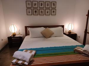 Postel nebo postele na pokoji v ubytování Indigaslanda Walawwa