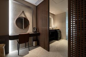 a bathroom with a vanity with a mirror and a sink at Green Hotel in Magong +105 photos