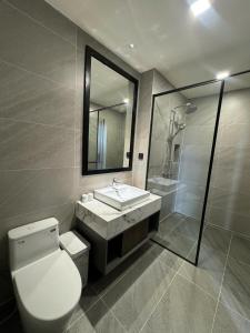 a bathroom with a toilet and a sink and a mirror at Mountain Hill in Mai Sơn