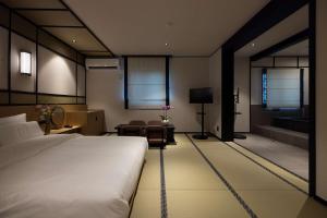a bedroom with a large bed and a living room at Mitasuya Ryokan Hotel Daejeon Yuseong in Daejeon +162 photos