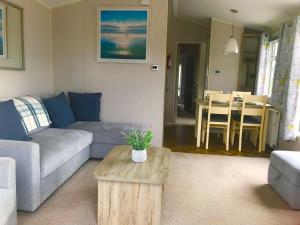 a living room with a couch and a coffee table at Beautiful durdle door holiday park in West Lulworth +14 photos