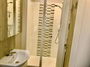 a bathroom with a sink and a shower at Beautiful durdle door holiday park in West Lulworth