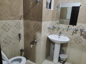 a bathroom with a toilet and a sink at Moon Living Apartment Peshawar in Peshawar