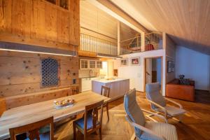 a kitchen and dining room with a wooden table and chairs at Zum Schmied in Bregenz
