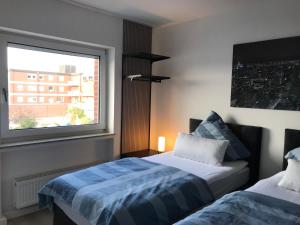 a bedroom with two beds and a window at Meckenheim in Meckenheim