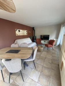 a living room with a table and a bed at Villa de l'oustaoun in Sanary-sur-Mer