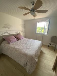 a bedroom with a bed and a ceiling fan at Villa de l'oustaoun in Sanary-sur-Mer