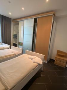 a hotel room with two beds and a window at The Greenstead in Hannover