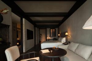 a hotel room with a bed and a couch and a table at Chengdu 6500 Hotel Kuanzhai Alley Citang Street Branch in Chengdu