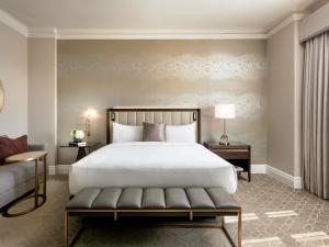 a bedroom with a bed and a couch at Fairmont Hotel Macdonald in Edmonton