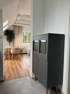 a black refrigerator in a room with a table at Appartement Khodai in Graz