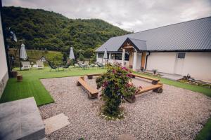 a garden with benches and flowers in front of a building at Adventure Tara in Foča