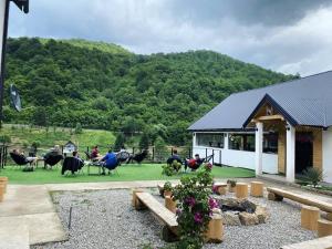 a group of people sitting in chairs in a yard at Adventure Tara in Foča