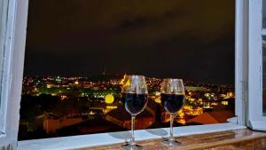 two glasses of wine sitting on a window sill at old Gomi iin in Tbilisi City +16 photos