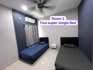 a room with a room two super single bed at LC Paragon Apartment in Labuan +10 photos