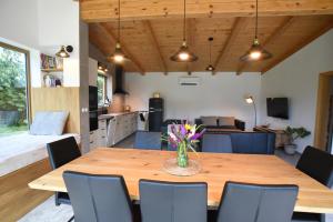 a kitchen and dining room with a wooden table and chairs at Apartmán Farma Byzhradec in Dobruška