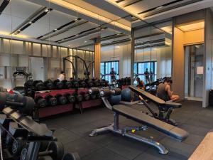 a gym with lots of machines and people in it at Sky View Agile Residence Bukit Bintang KL in Kuala Lumpur