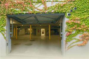 an open hallway with a green wall with flowers at VISIONAPARTMENTS Chemin des Epinettes - contactless check-in in Lausanne