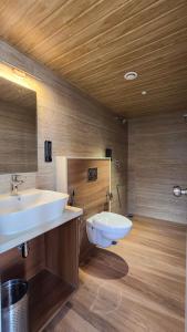 a bathroom with a sink and a toilet at Hotel Amigos in Bangalore