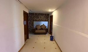 a hallway with a couch in a room at FabHotel Ayaansh in Hyderabad