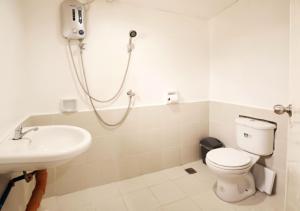 a bathroom with a shower and a toilet and a sink at Ocean Breeze Hostel by Daily Sweet in Moalboal +27 photos