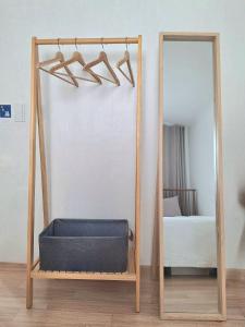 a mirror in a room with a blueinylinylinylinylinylinylinylinyl at Stay Hyuga Suwon in Suwon