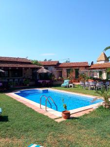 a swimming pool in the yard of a house at Le petit Olivier 